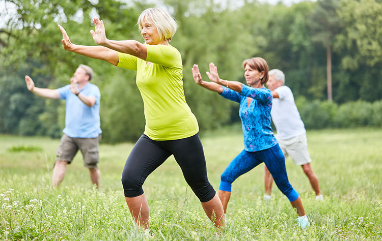People doing Tai Chi in the open air